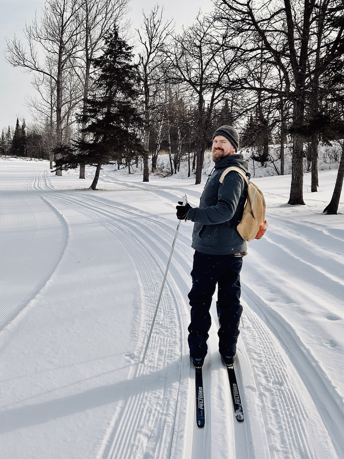 A man skiing on a winter trail