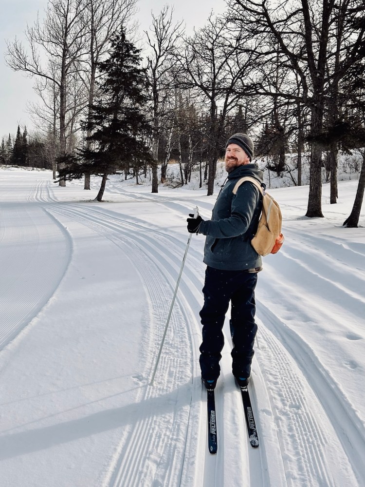 A man skiing on a winter trail